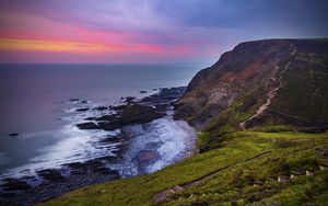 Preview wallpaper coast, sunset, rocks, surf