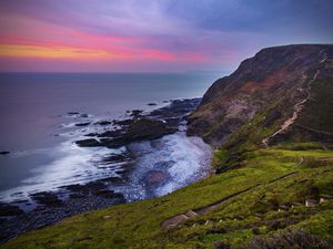 Preview wallpaper coast, sunset, rocks, surf