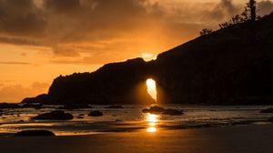 Preview wallpaper coast, water, rocks, sun, sunset, dark