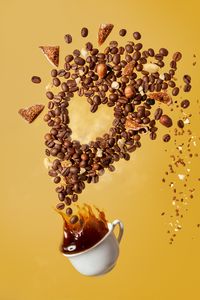 Preview wallpaper coffee, cup, coffee beans, nuts, splashes