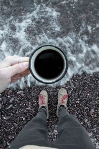 Preview wallpaper coffee, cup, legs, hand, pebbles, sea