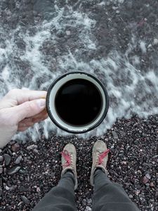 Preview wallpaper coffee, cup, legs, hand, pebbles, sea