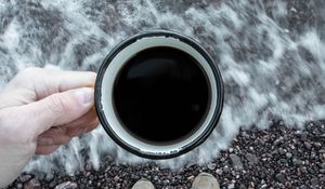 Preview wallpaper coffee, cup, legs, hand, pebbles, sea