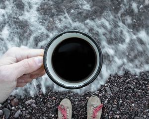 Preview wallpaper coffee, cup, legs, hand, pebbles, sea