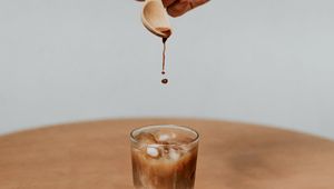 Preview wallpaper coffee, drink, ice, hand, spoon, drops