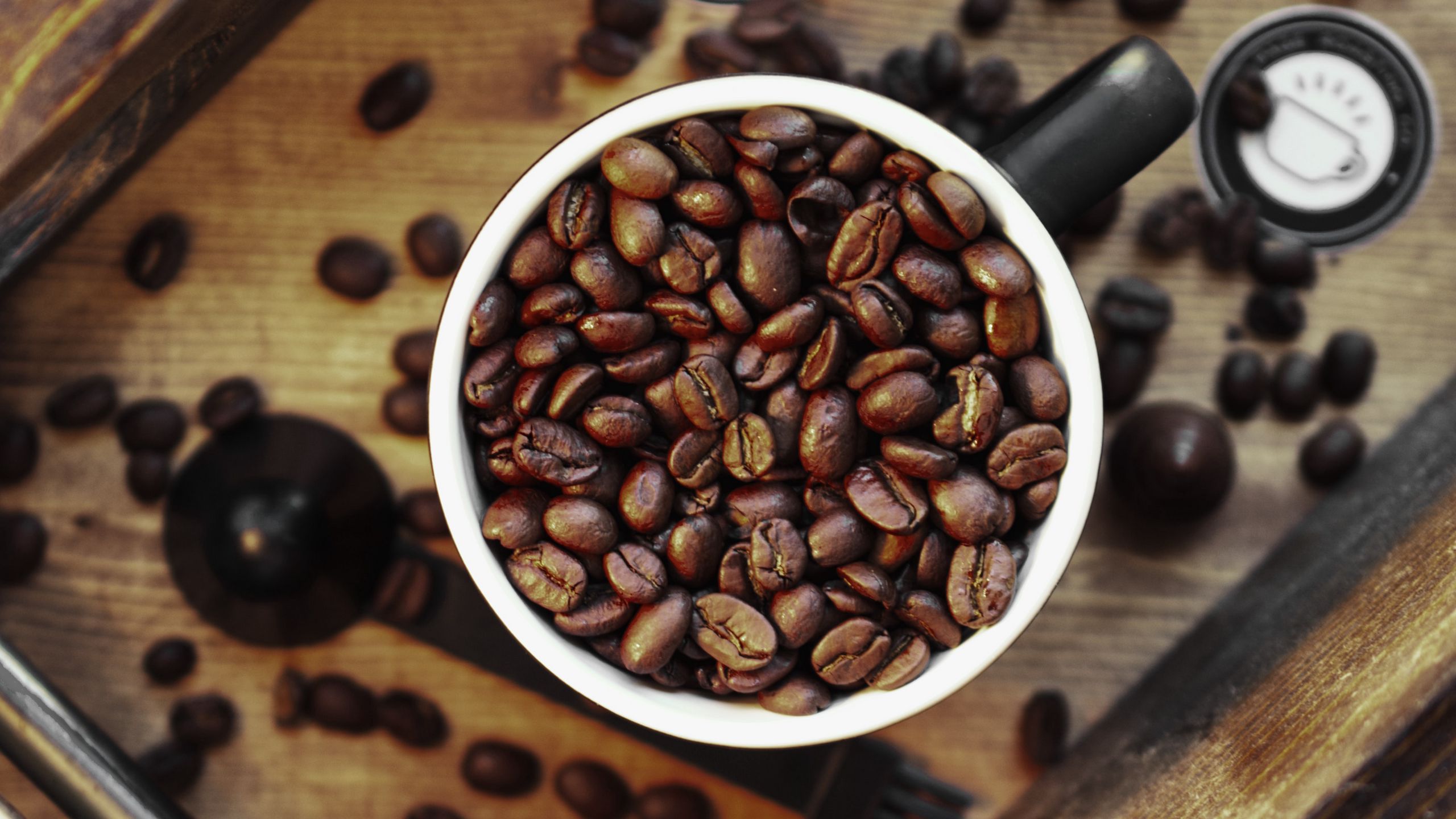 Download wallpaper 2560x1440 coffee, grains, cup, surface widescreen 16 ...