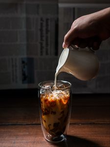 Preview wallpaper coffee, milk, ice, glass, hand