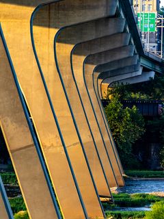 240x320 Wallpaper columns, bridge, river, grass, city