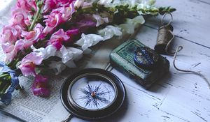 Preview wallpaper compass, flowers, newspaper, aesthetics