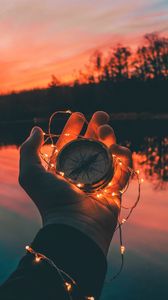 Preview wallpaper compass, garland, hand, river, evening