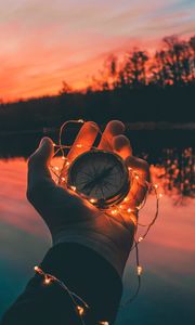 Preview wallpaper compass, garland, hand, river, evening