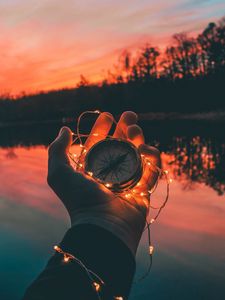 Preview wallpaper compass, garland, hand, river, evening