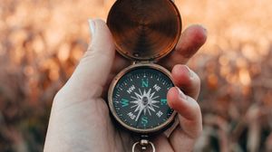 Preview wallpaper compass, hand, fingers, travel