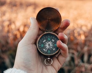 Preview wallpaper compass, hand, fingers, travel