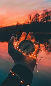 Preview wallpaper compass, hands, sunset, light