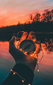 Preview wallpaper compass, hands, sunset, light