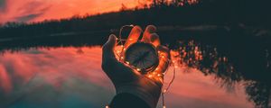 Preview wallpaper compass, hands, sunset, light