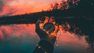 Preview wallpaper compass, hands, sunset, light