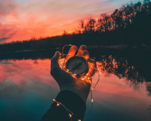 Preview wallpaper compass, hands, sunset, light