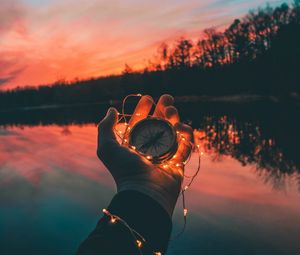 Preview wallpaper compass, hands, sunset, light