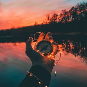 Preview wallpaper compass, hands, sunset, light