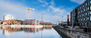 Preview wallpaper construction crane, buildings, river, reflection, ripples