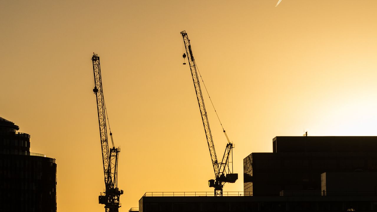 Wallpaper construction cranes, buildings, cars, silhouettes, evening