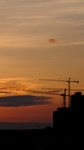 Preview wallpaper construction cranes, buildings, silhouettes, sunset, dark