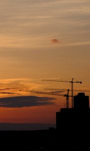 Preview wallpaper construction cranes, buildings, silhouettes, sunset, dark