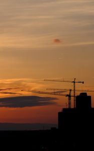 Preview wallpaper construction cranes, buildings, silhouettes, sunset, dark