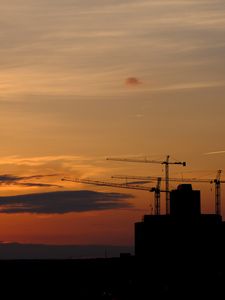 Preview wallpaper construction cranes, buildings, silhouettes, sunset, dark