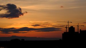 Preview wallpaper construction cranes, buildings, silhouettes, sunset, dark