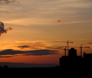 Preview wallpaper construction cranes, buildings, silhouettes, sunset, dark