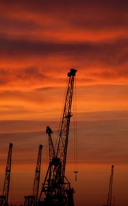 Preview wallpaper construction cranes, sunset, silhouettes