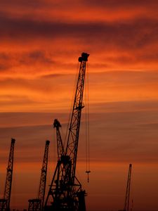 Preview wallpaper construction cranes, sunset, silhouettes