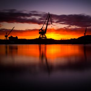 Preview wallpaper construction, water, sunset, reflection