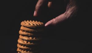 Preview wallpaper cookies, stack, dessert, hand, dark