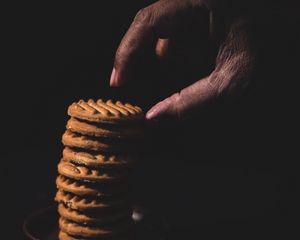 Preview wallpaper cookies, stack, dessert, hand, dark