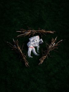 Preview wallpaper cosmonaut, space suit, branches, grass