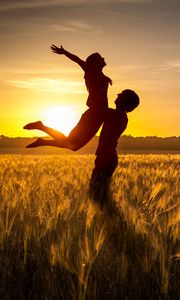 Preview wallpaper couple, love, sunset, field, grass, silhouettes