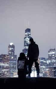 Preview wallpaper couple, roof, love, night city, skyscrapers, overview