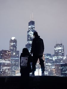 Preview wallpaper couple, roof, love, night city, skyscrapers, overview