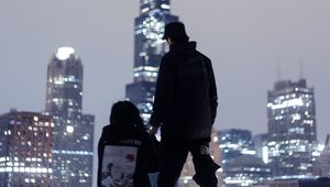 Preview wallpaper couple, roof, love, night city, skyscrapers, overview