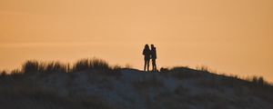 Preview wallpaper couple, silhouettes, hill, grass, evening