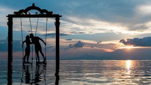 Preview wallpaper couple, swing, sea, romance, sunset, silhouettes