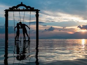 Preview wallpaper couple, swing, sea, romance, sunset, silhouettes