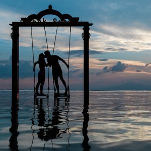 Preview wallpaper couple, swing, sea, romance, sunset, silhouettes