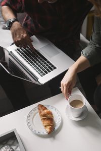 Preview wallpaper croissant, coffee, dessert, laptop, work, aesthetics