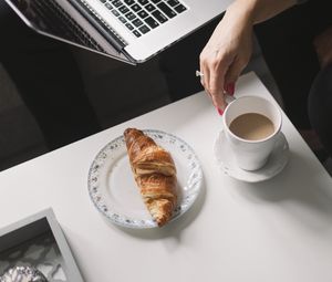 Preview wallpaper croissant, coffee, dessert, laptop, work, aesthetics