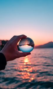 Preview wallpaper crystal ball, ball, hand, sunset, reflection